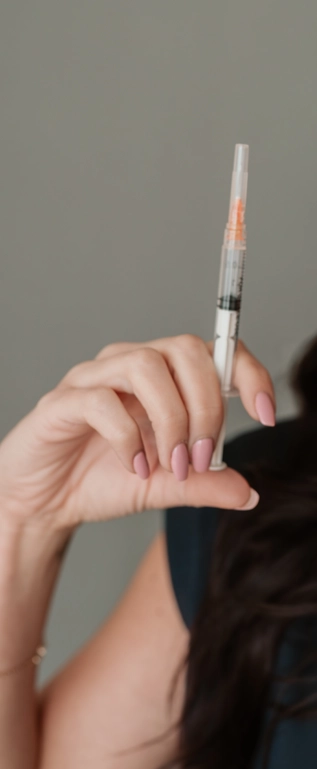 hand holding injection syringe closeup